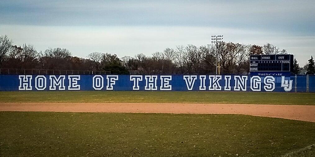 Example of custom printed fence slats installed on baseball field chain link fence
